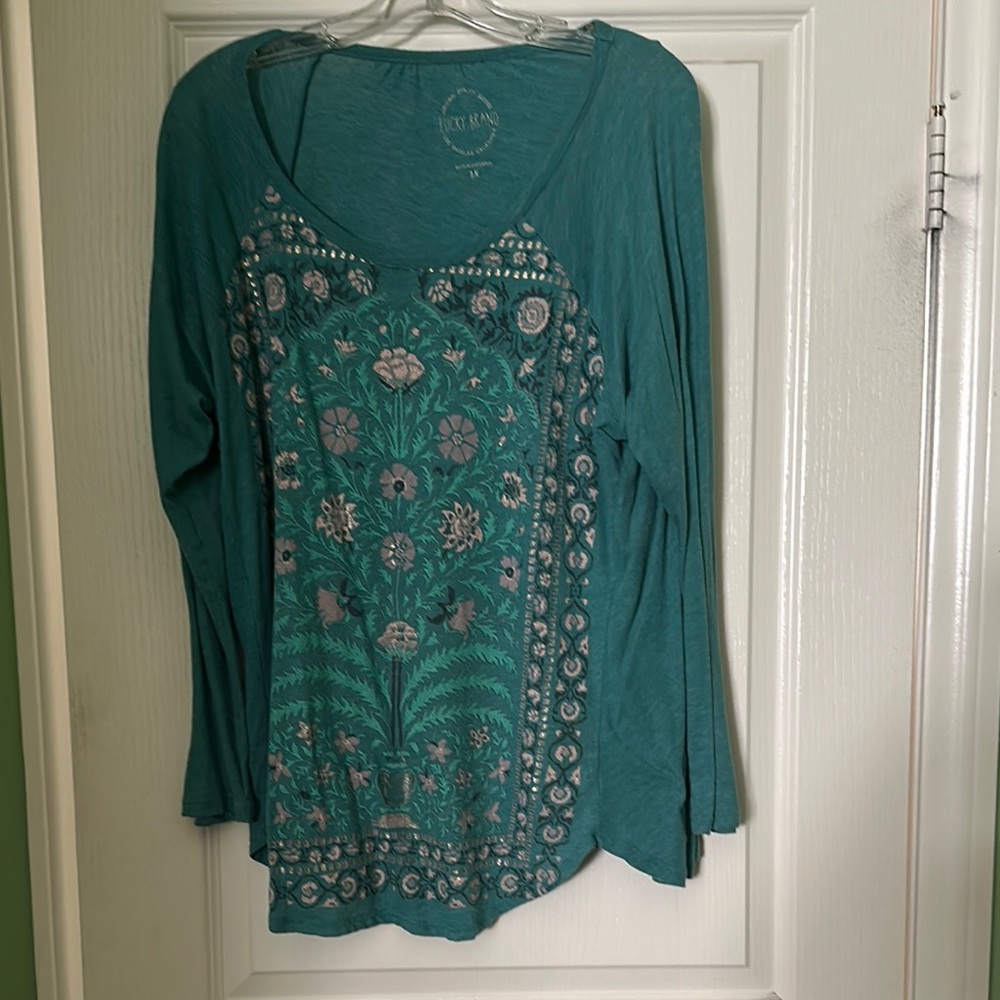Blue long sleeve graphic top with scoop neck and relaxed style